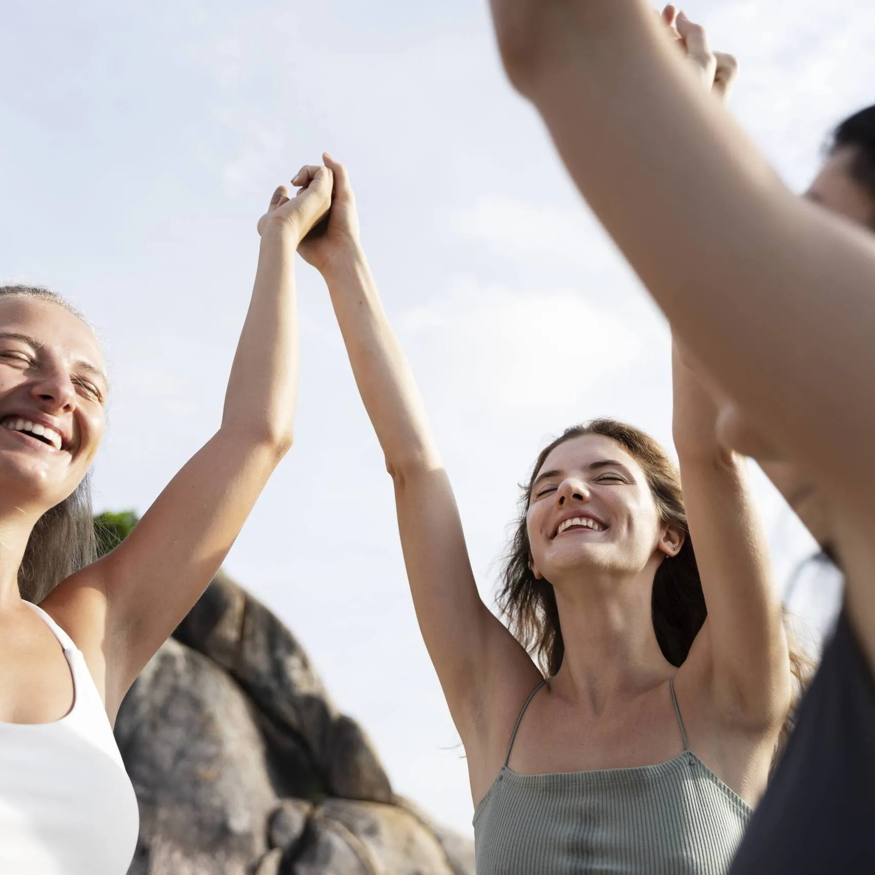 side view smiley women holding hands outdoors